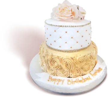a white cake with gold decorations and flowers on top