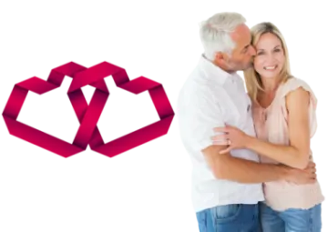 a man and woman hugging in front of a red ribbon