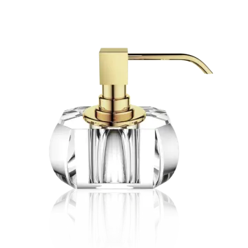 a gold and clear glass soap dispenser on a white background
