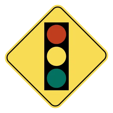 a traffic light on a yellow road sign