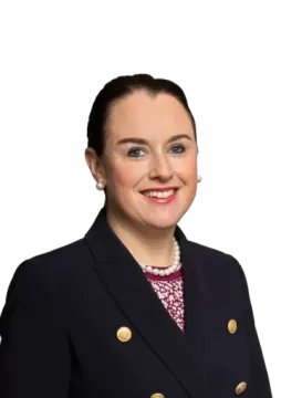 a woman in a black jacket and pink shirt