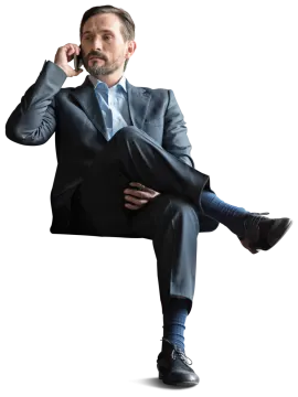 a man in a suit and tie sitting on a chair