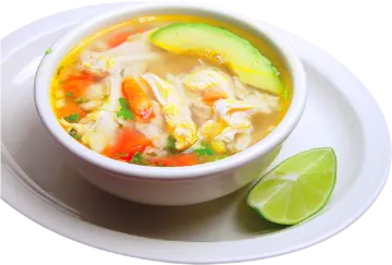 a bowl of chicken soup on a white plate