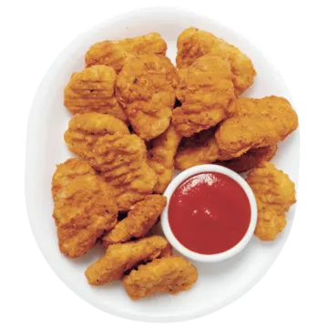 a plate of fried chicken with sauce on it