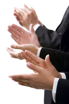 a man in a suit and tie holding his hands out