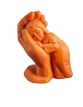 a clay sculpture of a woman holding a baby