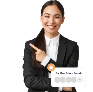 a woman in a business suit pointing at the camera