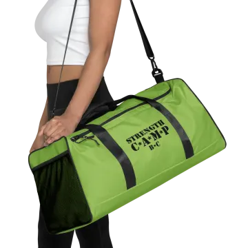 a woman carrying a green gym bag