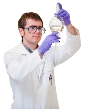 a man in a lab coat holding a flask
