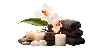 a white orchid and candles with spa towels