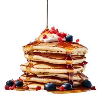 a stack of pancakes with syrup and berries