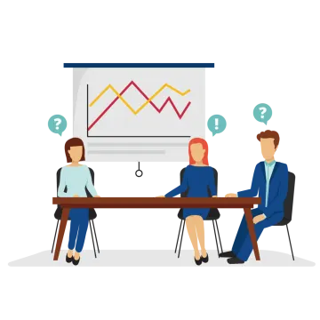 two people sitting at a table in front of a whiteboard