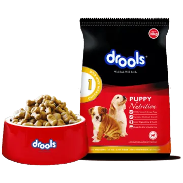 a bag of dog food next to a red bowl