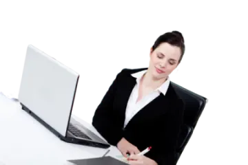 a woman sitting at a desk with a laptop