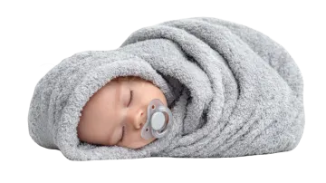 a baby doll wrapped up in a blanket