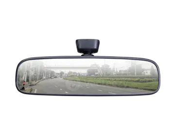 the rear view mirror of a car on a road