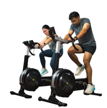 a man and woman on an exercise bike