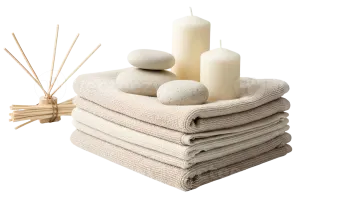 a pile of towels and candles on a white background