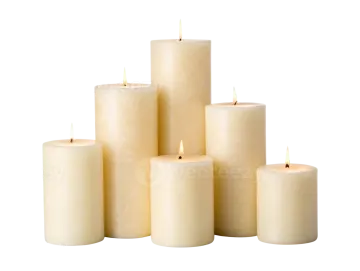 a group of white candles with one lit