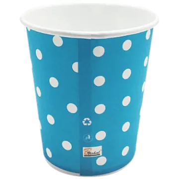 a blue cup with white polka dots on it
