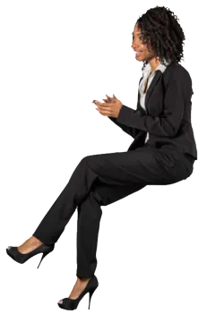a woman in a business suit sitting on the ground