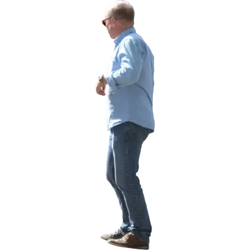a man in a blue shirt and jeans is walking