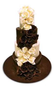 a three tiered cake with white and brown flowers