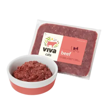 a white bowl filled with beef meat next to a bag of beef