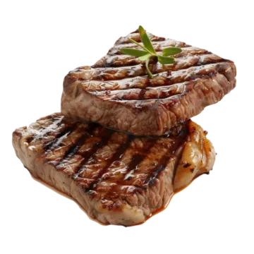 two pieces of steak with sauce on top