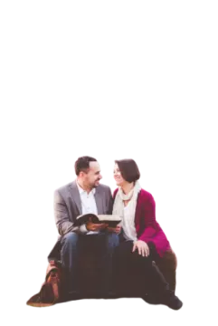 a man and woman sitting on top of a couch