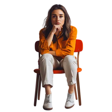 a woman sitting in a chair with her hand on her chin