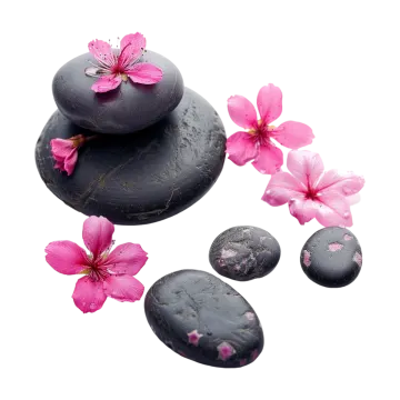 a pile of black stones with pink flowers