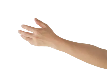 a person's hand reaching towards a white object