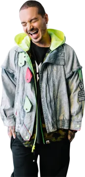 a man wearing a denim jacket with a green hoodie