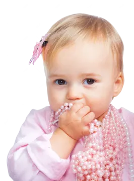 a baby girl wearing a pink dress and holding a pearl necklace