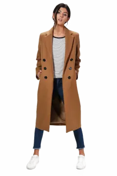 a woman wearing a camel coat and jeans