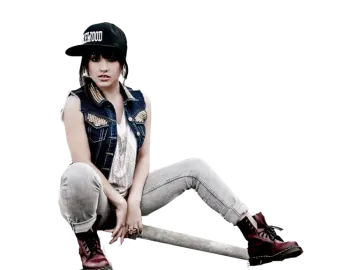 a woman sitting on the ground wearing a hat