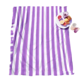a purple and white striped towel with fruit on it