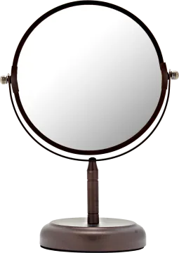 a round mirror sitting on top of a stand