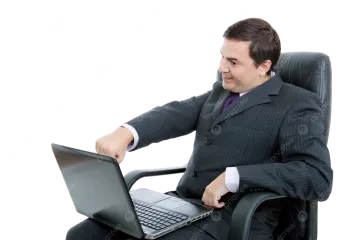 a man in a suit sitting on a chair with a laptop