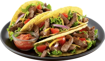 a plate of beef tacos with tomatoes and onions