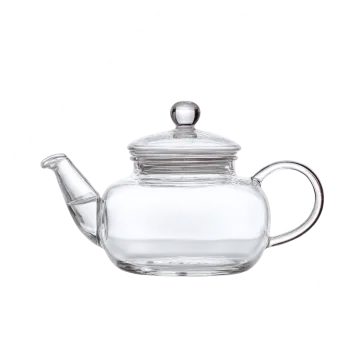 a glass teapot with a metal lid