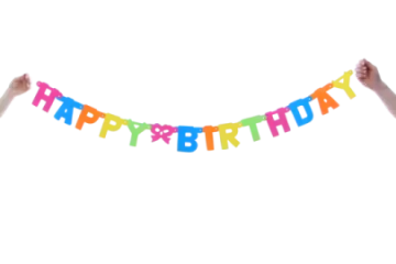 a person holding up a happy birthday banner