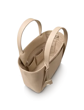 a beige leather tote bag on a white background