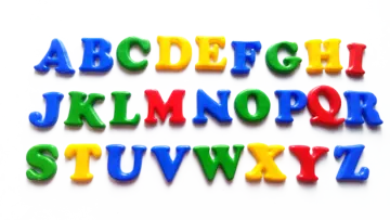 a set of colorful plastic letters on white background