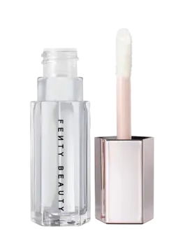 a white bottle of makeup next to a clear tube
