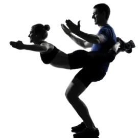 a silhouette of a man and woman doing a kick