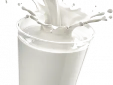 a glass filled with milk and splashing