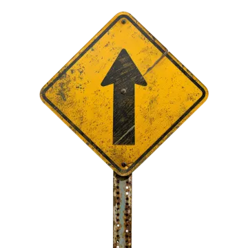a yellow sign with an arrow on it