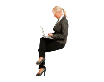 a woman sitting on the floor using her laptop